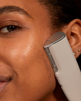 LUXE+ AND SERUM SET - Stone | Image of model using LUXE+ in stone on her cheek to remove peach fuzz