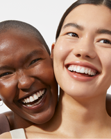 BOTANICAL KETOACID TONER - Two models smiling with smooth, glowing skin