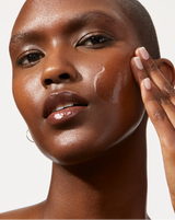 HYDRAFLASH COCOONING SERUM™ - Model applying COCOONING SERUM to her face with her fingertips