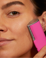 LUXE+ AND SERUM SET - Pop Pink | Image of model using LUXE+ in Pop Pink on her cheek to remove peach fuzz