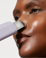 DERMAPORE+ - Lilac | model using DERMAPORE+ pore extractor in Peach Fuzz on her face