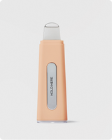 DERMAPORE+ - Peach Fuzz | DERMAPORE+ pore extractor tool in Peach Fuzz showing Hold Here text on device