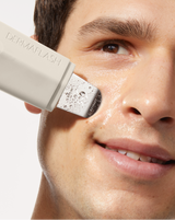 DERMAPORE+ PREP MIST - Model using the DERMAPORE+ device in Stone on his cheek