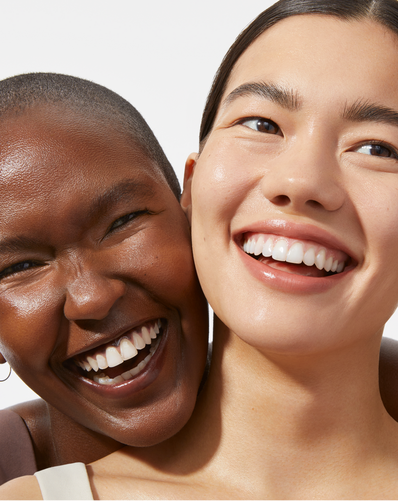 BOTANICAL KETOACID TONER - Two models smiling with smooth, glowing skin 