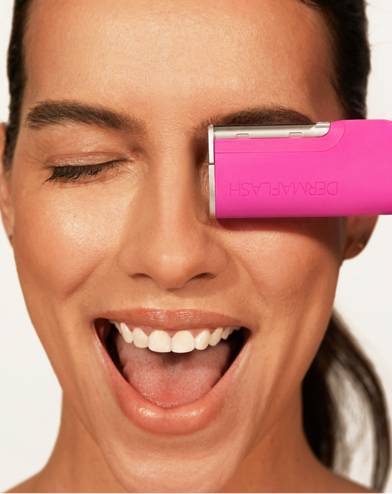 DERMAFLASH LUXE+ - Pop Pink | Model holding LUXE+ in Pop Pink near her face 